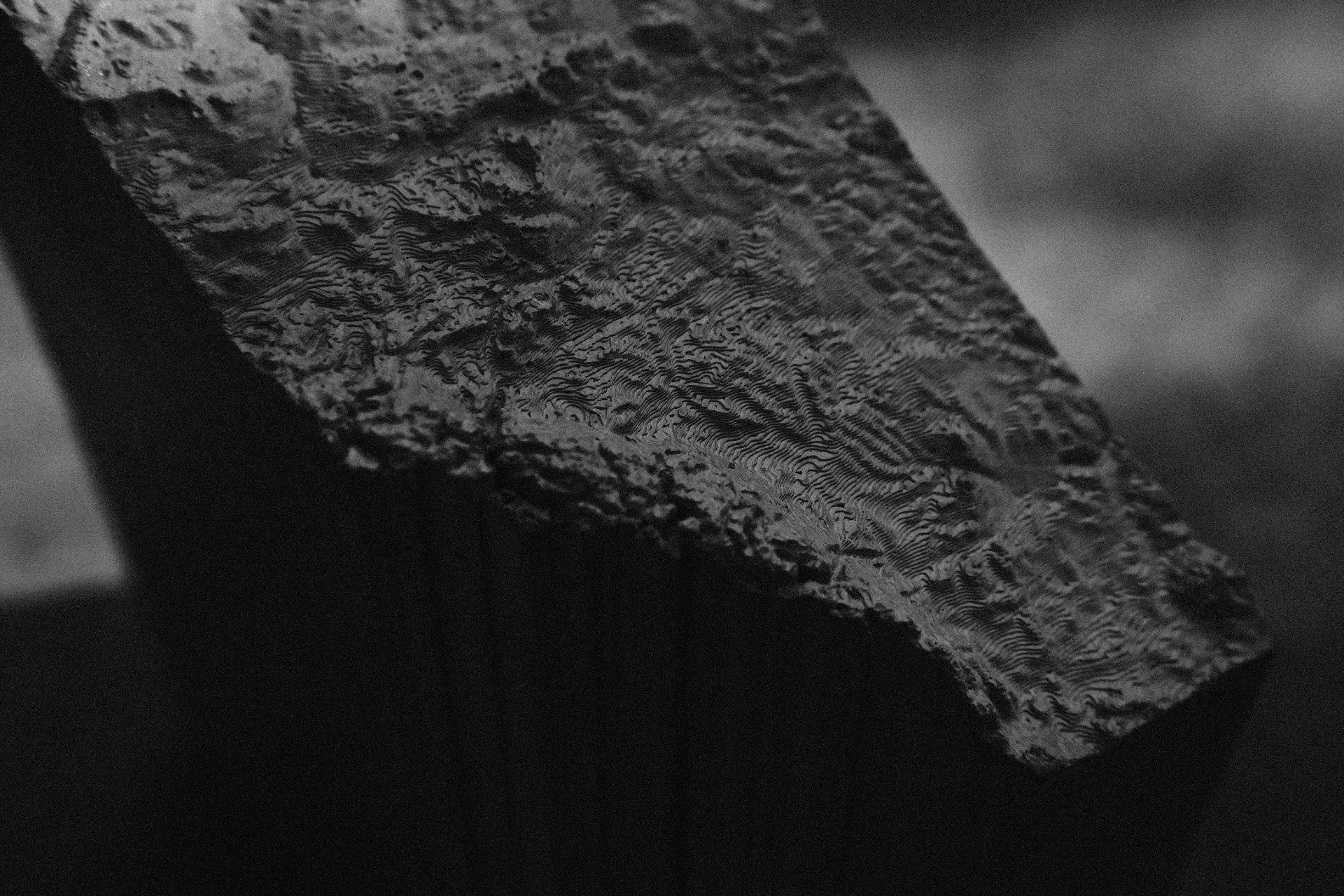 A cast concrete object in studio light